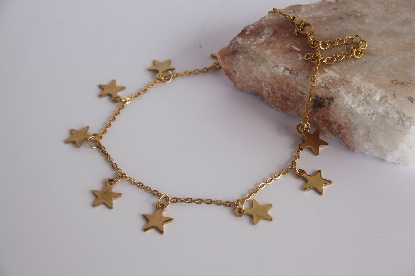 StarsIntroducing our Stars Anklet, a celestial-inspired accessory that adds a touch of whimsy and charm to your ankle. This anklet features delicate star charms, beautifuStainless SteelStars